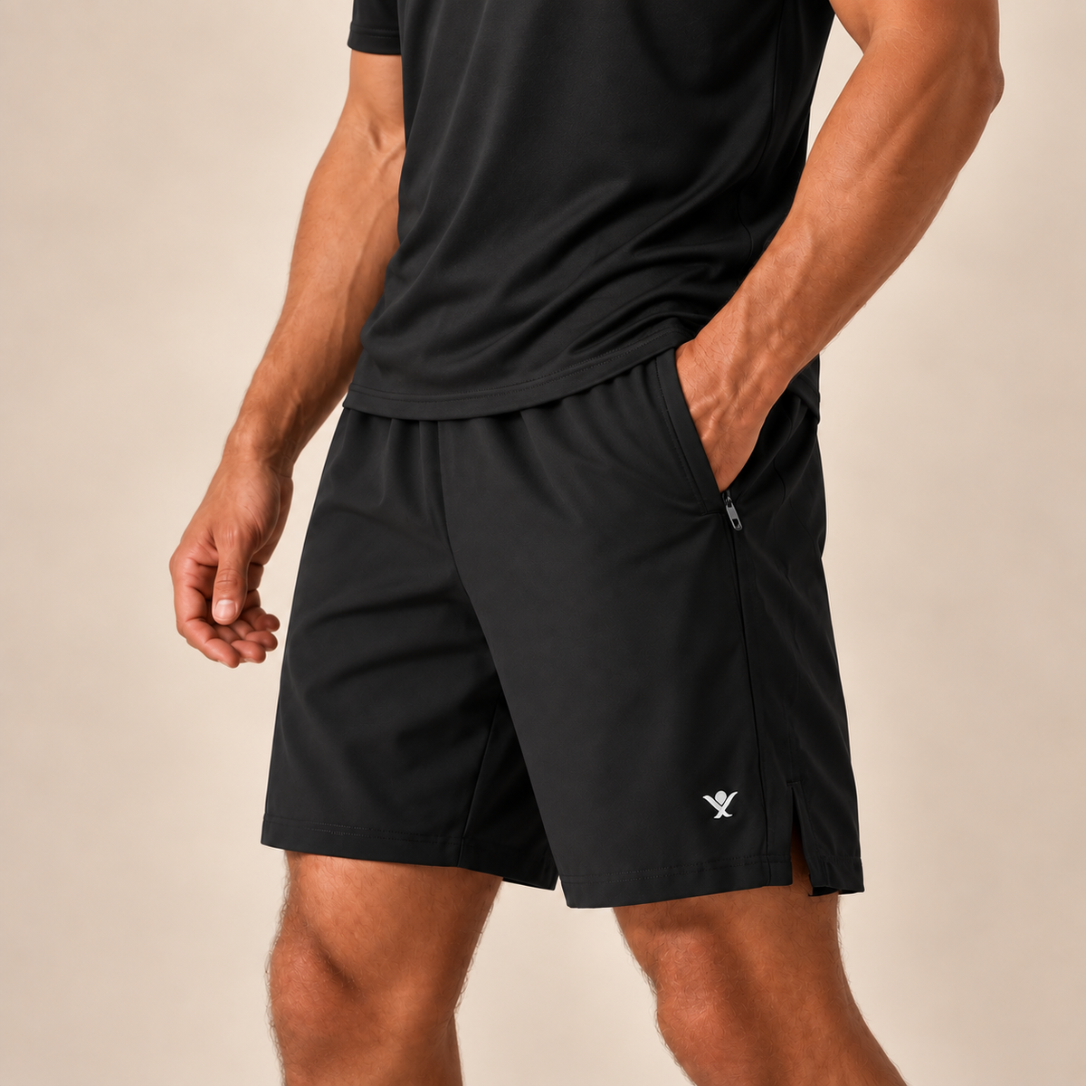 Male model in a relaxed black tee wearing JAG:LDN FlexLite zip pocket performance training shorts